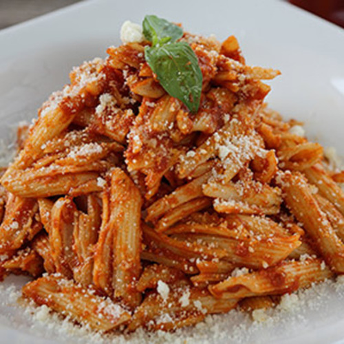 Arrabiata - Penne with spicy homemade tomato sauce, topped with grated parmesan cheese served with garlic bread.