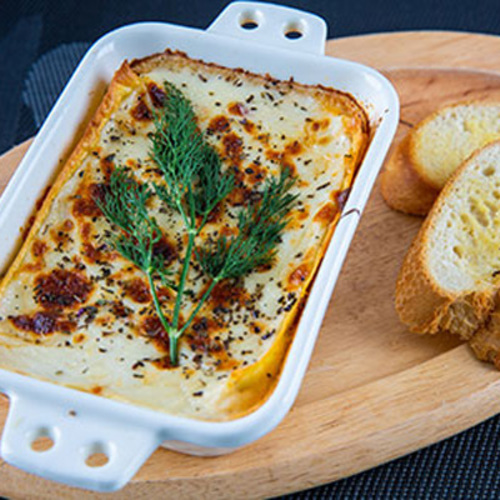 Lasagna - Layers of pasta with bolognese sauce, bechamel, mozzarella cheese, parmesan cheese, oregano on top , olive oil .