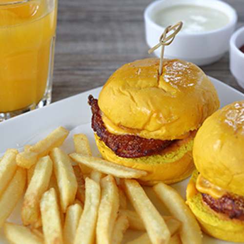 Kids Chicken Burger - Two sliders of chicken berger sandwish served with fries and orange juice.