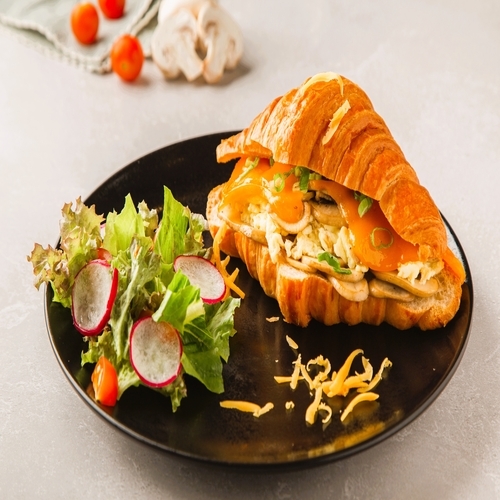 Loaded Croissant - Croissant , sauteed mushroom , egg , cheddar cheese , loloroso , cherry tomato , romaine lettuce.