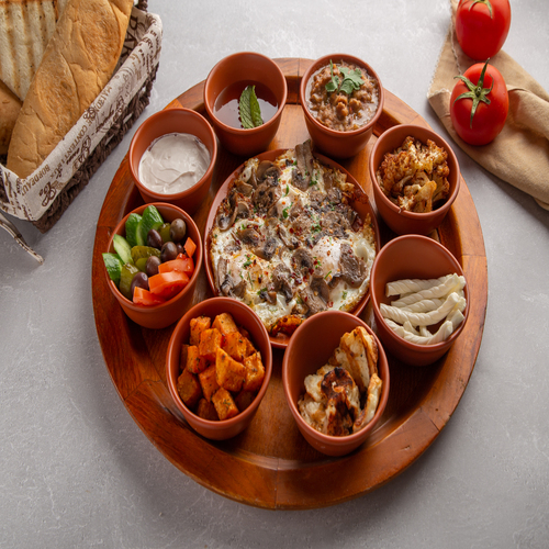 Zephora Breakfast - Breakfast tray with sunny side up egg mushroom tomato & potato cubes , foul ,cauliflower, halloumi, Turkish cheese, Thick cream and honey, tomato , cucumber with side bread basket  served with teapot