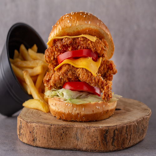 Double chicken burger - Two pieces of chicken breast topped with 2cheddar cheese slice , tomato, jalapeno, lettuce and zephora special sauce ,served with french fries