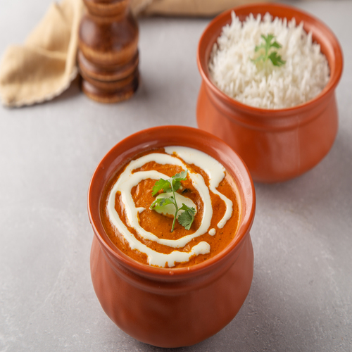 Butter Chicken - Savor tender chicken in rich, creamy tomato sauce & butter sauce served with rice