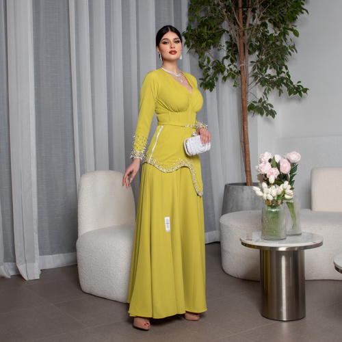 yallow green dec - A stylish apple-green dress crafted from crepe kainz fabric, adorned with pearl, silver, and off-white crystal embroidery. It features a luxurious design with a side crystal zipper, adding a modern and elegant touch, making it ideal for evening events and special occasions.