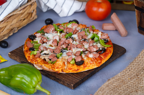 Hot Dog Pizza - Indulge in the fusion of pizza and hot dog in our irresistible Hot Dog Pizza, topped with juicy sausage, melted cheese, and favorite hot dog toppings on a crispy crust.