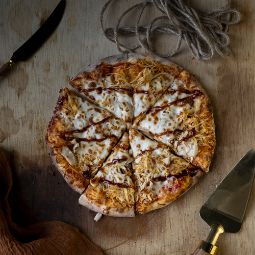 BBQ Pizza - Pizza dough with pizza sauce, boneless chicken, mushrooms, mozzarella cheese, and BBQ sauce