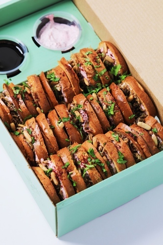 Musakhan mini brioche box - 15 pcs - 15 pieces of mini brioche Musakhan, of shredded sumac-seasoned chicken, caramelized onions, and toasted pine nuts