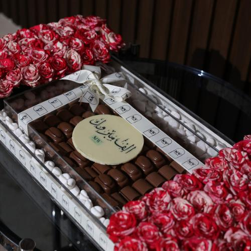 Taya Tray - It consists of a mix of pink baby roses with a chocolate box decorated with white stones Kindly write a sentence on the card in the box below