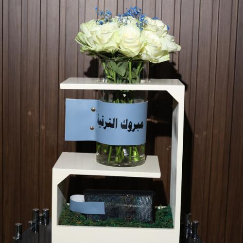 Sama Stand - It consists of a white rose and a blue nemnem with a piece of leather and a rectangular acrylic for money with a black net with a wooden stand Kindly write a sentence on the leather, a sentence on the card, and the amount of money in the box below