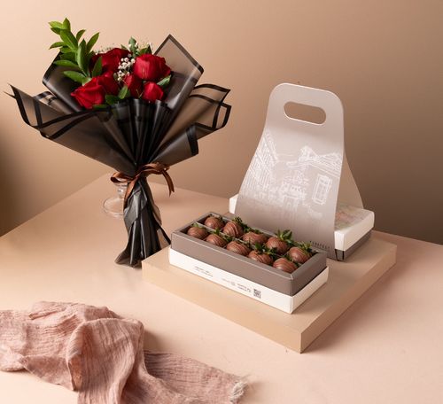 Gift box of chocolate strawberry with a flower bouquet