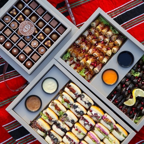 Kashta Offers - Three large boxes:
- One box of stuffed grape leaves and musakhan (80 pieces: 40 grape leaves and 40 musakhan)
- One large box of mini sandwiches (25 sandwiches with 5 different fillings: chicken chutney, labneh with buttermilk, Kraft cheese, halloumi, and olive cream cheese)
- One chocolate box (36 pieces of Belgian chocolate with three different fillings)