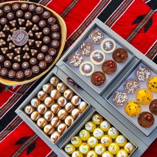 Wanasah Offers - Belgian Gold Chocolate Tray with three different fillings, 70 pieces
- Mixed Aqili Cookies with Saffron, 25 pieces, and Dates with Pecans, 25 pieces, totaling 50 pieces per box
- Mousse in Cups with tropical fruit, chocolate, coconut, and tiramisu flavors, 18 cups