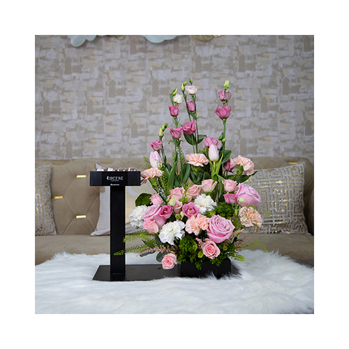 Sophia - Height: 55cm
Width: 50cm
A wooden stand with two bases containing mixed flowers and Belgian chocolate.