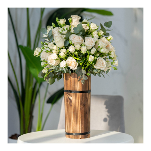 Lucene - Declan 21 - Height: 65cm
Width: 25cm
A wooden vase containing white roses and white baby roses.