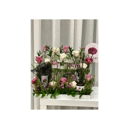 A Stand of Natural Roses in White and Pink, With a Spray Bottle, a Diffuser, and an Acrylic Phrase - A stand of natural roses in white and pink, with a spray bottle, a diffuser, and an acrylic phrase