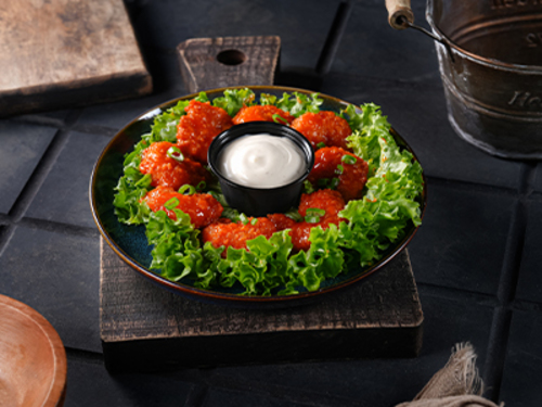 Bafalo Shrimps - Buffalo shrimp battered and deep fried shrimps and mix with homemade buffalo sauce served with ranch dressing.