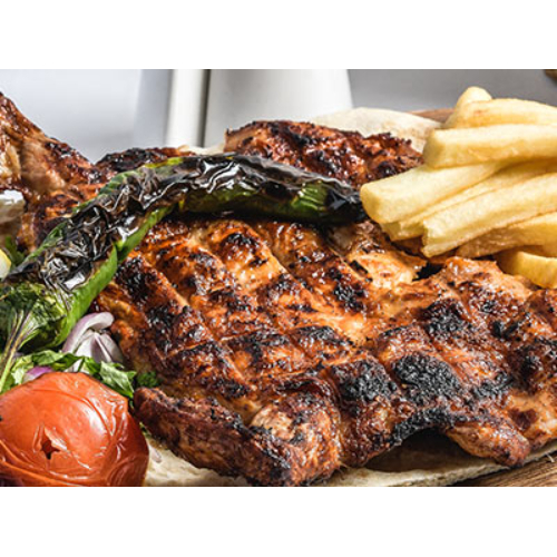 Grilled Baby Chicken - Whole boneless grilled, chicken, served with French fries, tomatoes and garlic sauce.