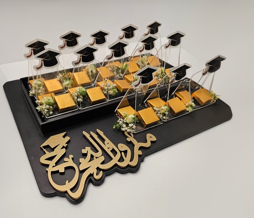 Fantastic Chocolate  - Mabrouk Graduation Chocolate Tray with Fresh Flowers - 13 Pieces of Crunchy Kinder Chocolate and Raffaello Chocolate served on a tray with the message 