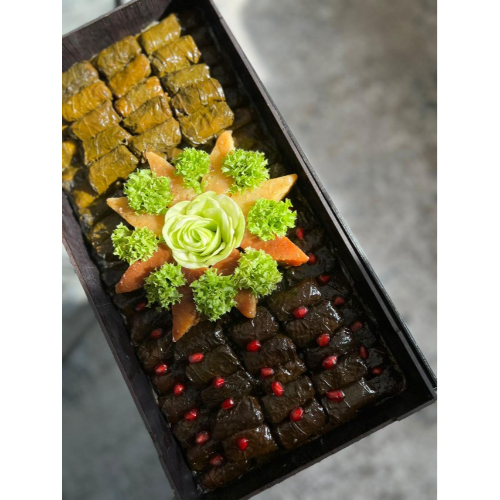 Waraq3nab in Wooden Tray (100 pcs) - Experience the exquisite taste of our wrapped vine leaves, beautifully presented in a wooden tray. Each piece is carefully crafted and available in a variety of flavors to suit your taste