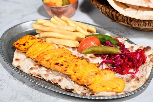 Shish Tawook - 10 pieces of fresh chicken without bone with the iranian dressing and served with french fries with warm bread.