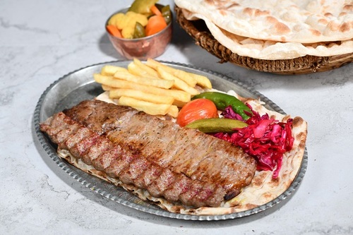 Kabab Sultani - One skewers of kabab barg and one skewers of iranian kabab with mix rice the iranian dressing served with daqos with warm bread.