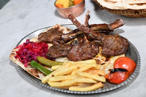 Ribs - Pieces of ribs grill in coal with the iranian dressing in a manner yas and served with french fries and surfs yas with warm bread.