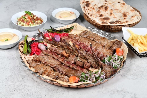 Tray Makhsous protein Meat _ 6 to 7 persons - 5 pieces of lamb shops, 2 lari kebab, 2 bargh kabab, 3 Iranian kebab, 2 meat tikka, Shirazi salad, 2 hummus, with Yas service and tandoor bread