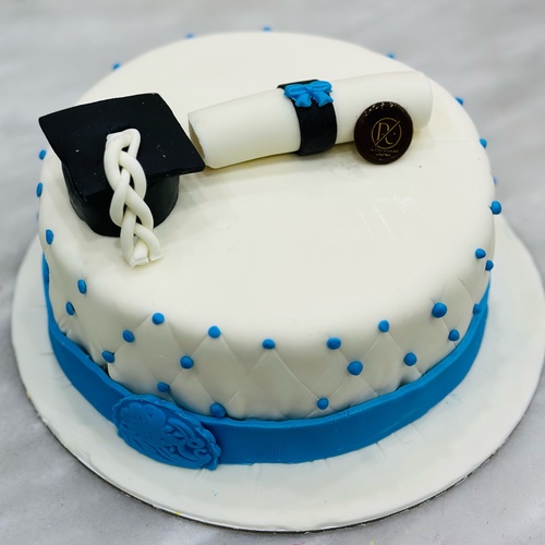 Graduation cake - Soft sponge cake (vanilla or chocolate), soft butter cream or fresh cream according to choice, rich filling, professional decoration with sugar or chocolate paste with graduation cap and certificate forms, and custom congratulatory phrases.