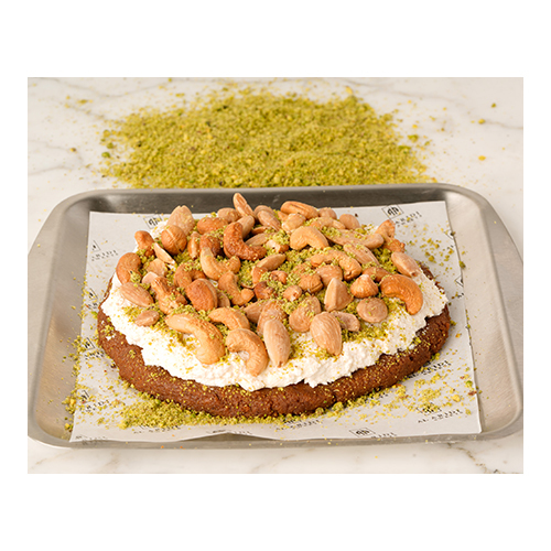 Mafrooka - A thick layer of roasted semolina mixed with sugar syrup, topped with cream and roasted nuts.
