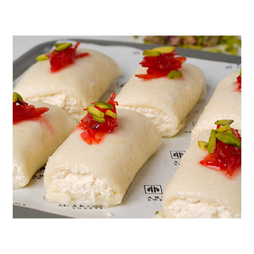 Halawet Al Jebn - Prepared with sweet cheese, semolina, sugar syrup and rose water,
served with fresh cream and garnished with pistachio and rose jam.