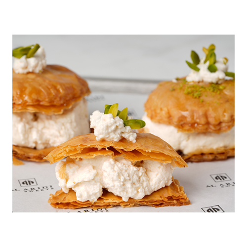 Warbat Kashta - Prepared from crisp dough sheets, stuffed with fresh cream, and sweetened with syrup