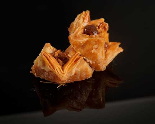 Baklawa Cashew - Prepared from crisp dough sheets, stuffed with Cashew and sweetened with syrup.