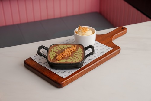 Kunafa Brownies - Brownie with Kunafa covered topped with Belgium chocolate , Pistachio Sauce and served with ice cream.