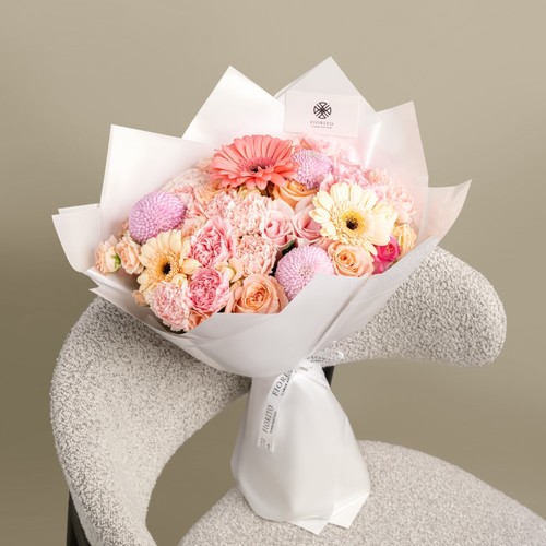 Fancy Mix - Roses and gerbera wrapped in wrapping paper. Adds a touch of elegance and joy to any celebration.