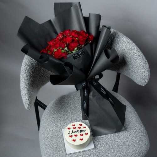 Red Magic - Magical red baby roses wrapped in wrapping paper and a delectable cake. Perfect for anniversaries, birthdays or expressing love. Note: Cake writing is customizable.