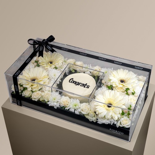 Lustrous - Baby roses and gerbera in an acrylic box with a cake. A heartfelt way to congratulate loved ones. Note: Cake writing is customizable.