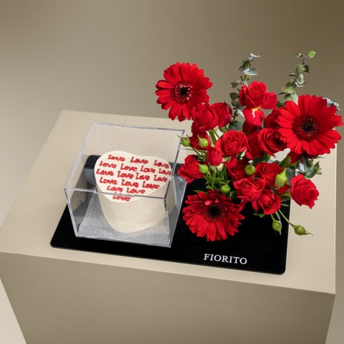 Timeless Romance - An acrylic tray filled with baby roses, gerbera and a cake. A perfect gift to honor your enduring love and commitment. Note: Cake writing is customizable.