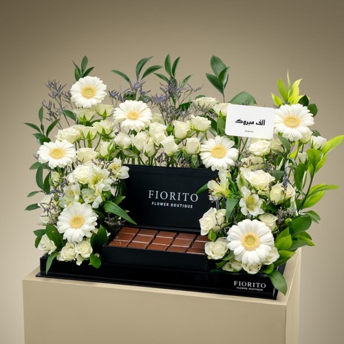 Royal Triumph - A tray topped with baby roses, gerbera, alstroemeria, and a box of delectable French chocolates. Perfect for milestones, achievements, and joyous celebrations.