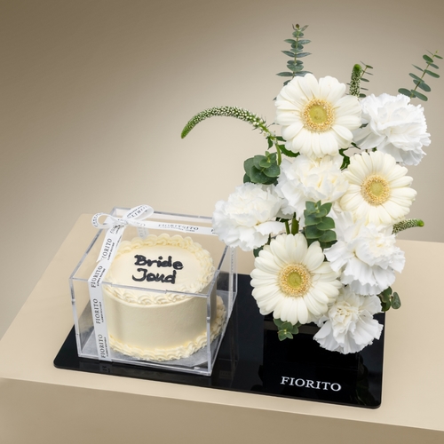 Timeless Bride - An acrylic tray topped with gerbera, veronica, and carnations with a cake. A perfect way to congratulate the bride on her most precious moment. Note: cake writing is customizable.