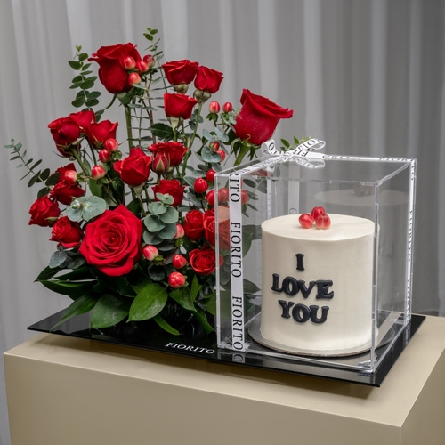 Timeless Love - An acrylic tray topped with baby roses, roses, and hypericum with a cake. It conveys a tender message of love, perfect for a romantic gesture or special occasion. Note: cake writing is customizable.