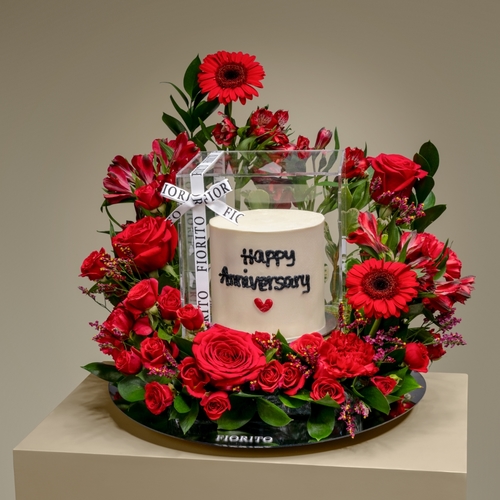 Heartfelt Harmony - A reflective glass tray with roses, baby roses, alstroemeria and a cake. Ideal gift to show your loved one how deeply you care and to celebrate the intensity of your relationship. Note: Cake writing is customizable.