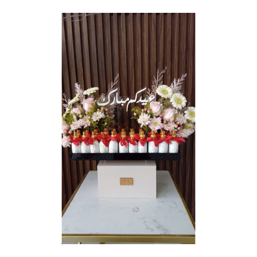 Eid Mubarak Stand - Wooden top, black acrylic tray
Decorated with gerbera, baby rose and cherry flowers
It contains 18 perfumes, 35 milliliters of powder, with “Eid Mubarak” written on the perfume in gold, decorated with a Chinese ribbon of your choice, measuring 42 cm, acrylic.”