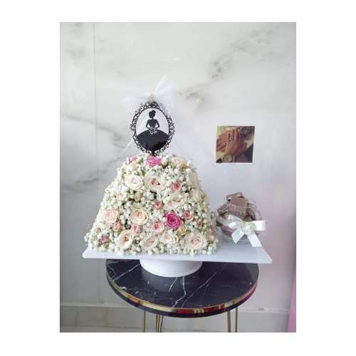 The Most Beautiful Brides - Standing on a model of a bride whose dress is made of natural flowers of your choice, with a small vase of luxury Belgian chocolate and a card.