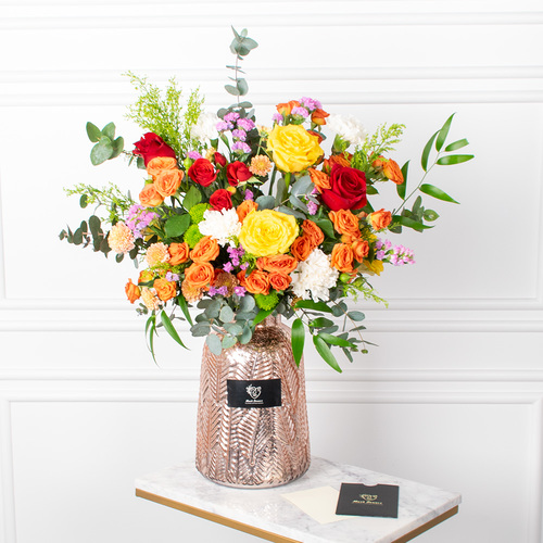 Rose And More - Roses, baby roses, chrysanthemums, and carnations arranged beautifully in a vase with a card.