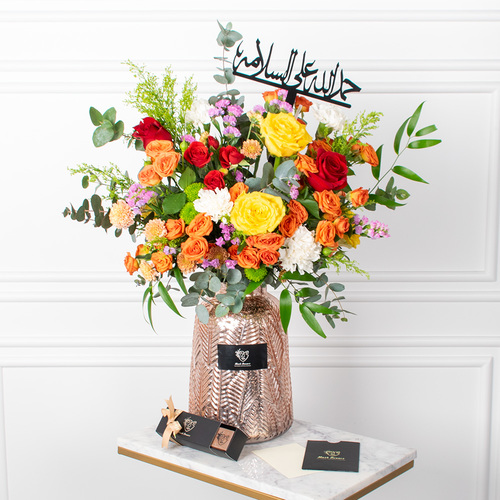 Rose Enchant - Roses, baby roses, chrysanthemums, and carnations arranged beautifully in a vase with a card, an acrylic topper, and chocolates.