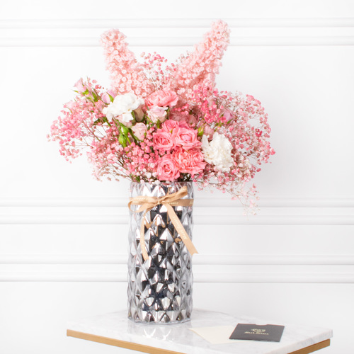 Barbito Bouquet - A vase that contains carnation, gypsophila and roses with a chocolate box and acrylic name and card.