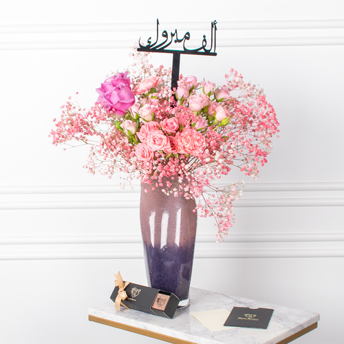 Pinkie Flowers - A vase that contains carnation and roses with a chocolate box and acrylic name and card.