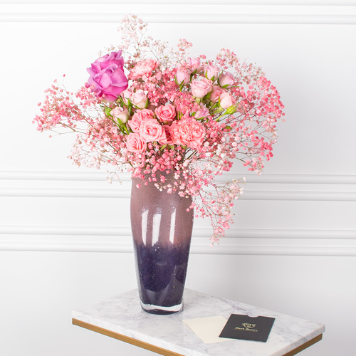 Pinky And Flowers - A vase that contains gypsophila and roses with a card.
