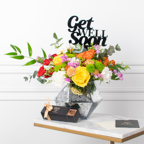 Silver Bouquet - Roses, chrysanthemums, and carnations arranged beautifully in a vase with a box of chocolates, a card, and a topper.