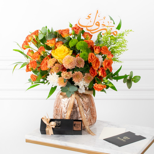 Samara - A vase filled with chrysanthemums, roses, carnations and eucalyptus along with chocolates.